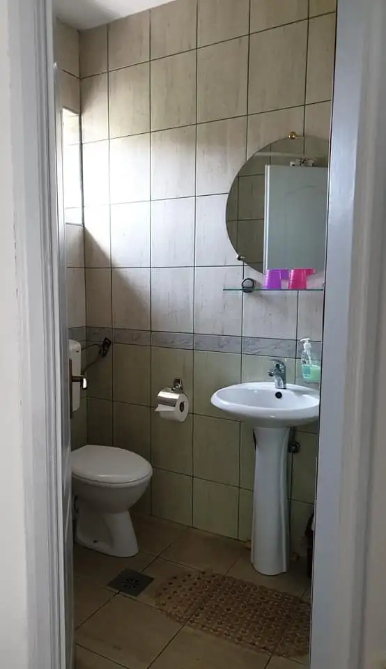 Bathroom with a washbasin, mirror and shower cabin
